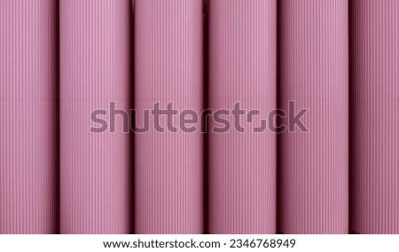Full frame row of large scale, industrial storage tanks or silos in a Barbie pink colour at a chemical plant with copy space above