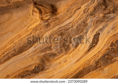 Full frame of sandstone rock pattern, Rock formation, natural of sand stone on beach in Australia, line and curve of stone use for background