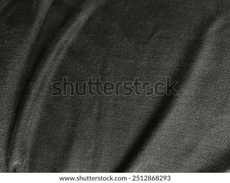 Full Frame Shot Of Black Polyester Fabric Texture And Background, Plush Bottom Thick Warm Denim Sewing Material Diy Clothing or Pants or Jeans. Balck Fabric Background Texture Close-up

