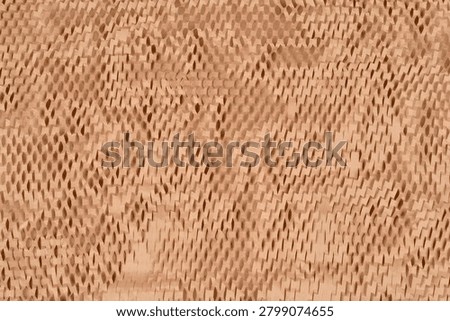 A full frame shot captures the textured surface of stretched brown kraft honeycomb paper wrap showing its regular die cut geometric pattern.