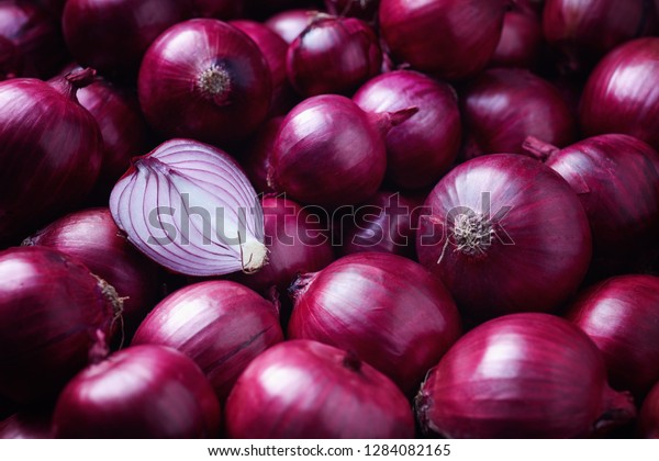 Full Frame Shot Of Purple Onions. Fresh\
whole purple onions and one sliced\
onion.