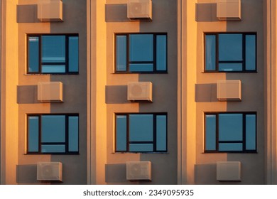 Full frame shot of windows and conditioners in sunset light - Shutterstock ID 2349095935