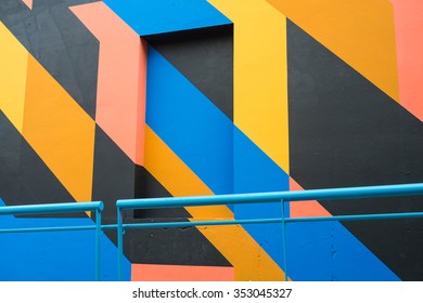 Full frame take of a facade painted with a geometric pattern