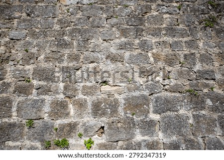 Full frame texture of an ancient medieval castle wall made of weathered ashlar stone blocks in Jajce, Bosnia and Herzegovina
