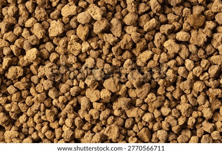 Full frame texture background of brown potting soil granules (Akadama)