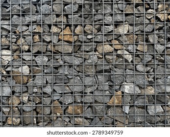 Full frame texture background of a gabion wall filled with natural stones