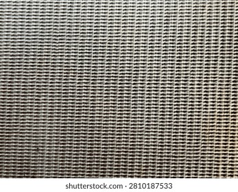 Full frame texture of a gray woven vintage amplifier speaker grille cloth material close up