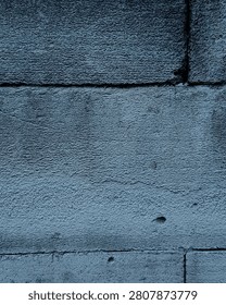 Full frame texture of grey concrete breeze blocks wall with blueish tone