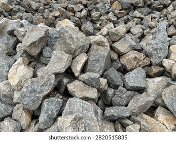 Full frame texture of rough grey crushed stones and granite rocks pile