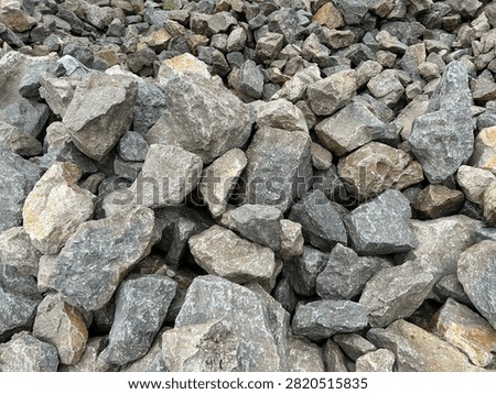 Full frame texture of rough grey crushed stones and granite rocks pile