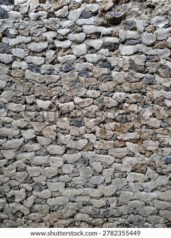 Full frame texture of rough volcanic stone masonry wall background.