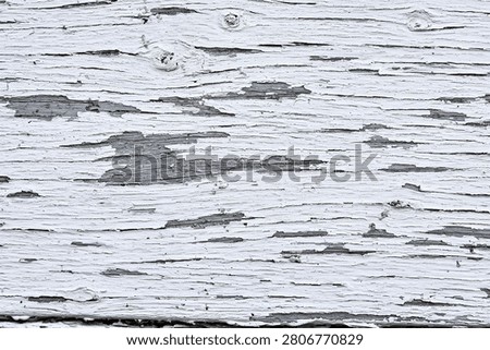 Full frame texture of severely distressed white paint on old wood