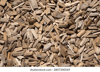 Full frame top view texture of natural brown wood chips mulch used for garden landscaping and playground safety surfacing.