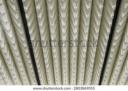 Full frame view of rows of hanging soundproof acoustic baffles installed on ceiling surface for noise reduction and sound dampening inside modern facility