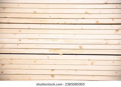Full frame view stack of pine lumber with straighter grain at home improvement hardware store shelves uses for framing, houses, sheds, and other structures, timber construction. Industrial background