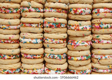 Full frame view of stacked cookie sandwiches with sprinkles.