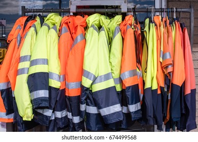 Full Frame View Of Yellow And Orange High Visibility Protective Clothing On Rack