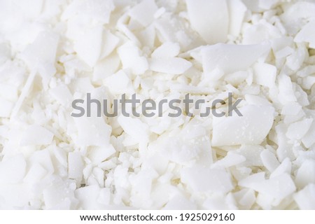 Full frame of white soy wax flakes for candle making, white background
