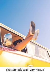 Full Freedom And Relaxation. Low Angle View Of Woman Stretching Out Her Legs Out Of The Window While Sitting Inside Of Minivan