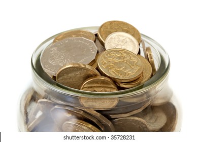 Full glass jar of Australian coins, over white background.