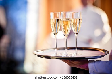Full glasses of champagne on tray