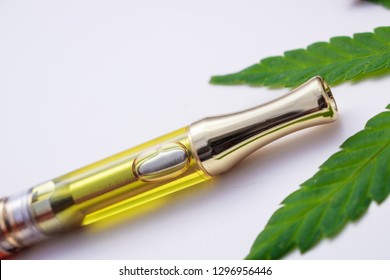 Full Gram Cannabis Oil (THC/CBD) & Terpenes In Vape Cartridge. Up Close With Weed Leaf On Side,