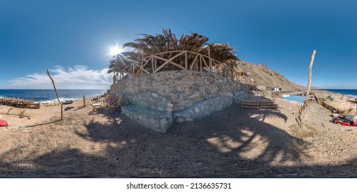 full hdri seamless spherical 360 panorama near thatched hut with daybeds and cushions for relaxing or palm tree hut on Red Sea coast in equirectangular projection ready for virtual reality VR AR 