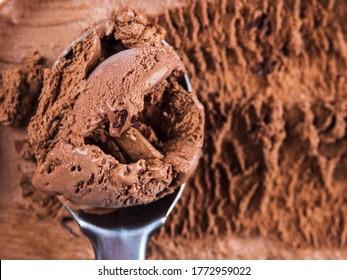 Full Ice Cream Scoop In Chocolate Ice Cream Tub. Macro Texture