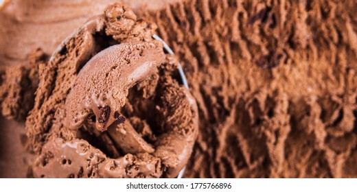 Full Ice Cream Scoop In Chocolate Ice Cream Tub. Macro Texture Banner