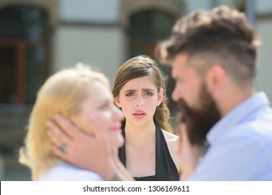 Full of jealousy. Romantic couple of man and woman dating. Jealous girl look at couple in love on street. Bearded man cheating his woman with another girlfriend. Unhappy woman feeling jealous.