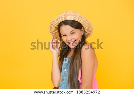 Full of joy. happy childhood. cheerful little girl wear straw hat. beach fashion for kids. small child on yellow background. holiday joy and activity. beauty. long-awaited summer vacation.