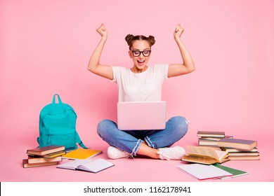 Full legs, body, size portrait of reader girl in blue jeans and white t-shirt with a laptop on her knees raises her fists up and joyfully shouts cheers isolated on bright pink background - Powered by Shutterstock