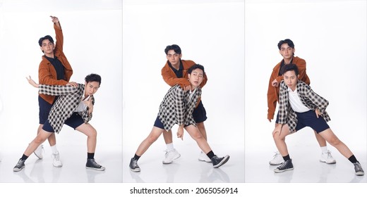 Full Length Of 20s Asian Tanned Skin Men Black Hair Hold Together As Gay LGBT, Wear Shirt Pants Blazzer Sneaker Shoes. Young Couple Modern Dance With Fun Happy Over Studio White Background Isolated