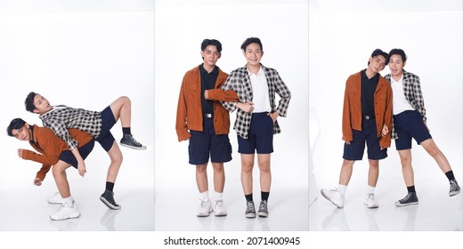 Full Length Of 20s Asian Tanned Skin Men Black Hair Hold Together As Gay LGBT, Wear Shirt Pants Blazzer Sneaker Shoes. Young Couple Modern Dance With Fun Happy Over Studio White Background Isolated