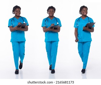 Full Length 20s Young African American Woman Medical Healthcare Nurse, Walking Forward Left Right, Wear Formal Blue Shirt Pants. Hospital Female Carry Patient Chart Over White Background Isolated