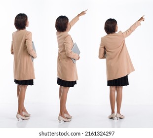 Full length 20s young Asian Business Woman businesswoman wear blazer skirt, pointing finger hand up. Office female carry laptop notebook coffee cup happy smile over white background isolated - Shutterstock ID 2161324297