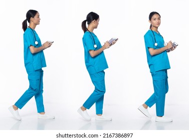 Full Length 20s Young Asian Woman Clinic Nurse, Walking Forward Left Right, Wear Blue Dress Pants Shoes Stethoscope. Smile Hospital Female Hold Patient Chart Over White Background Isolated