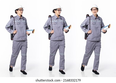 Full length 30s 40s Asian Woman Engineer Industry technician, walking forward left right, wear formal uniform safety gear. Smile factory female carry tube blueprint over white background isolated