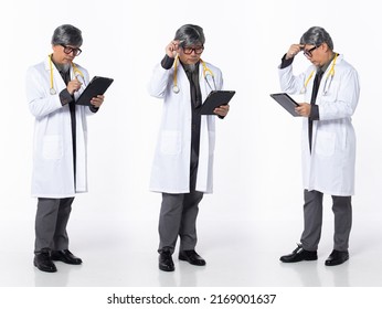 Full Length 50s 60s Asian Chinese Hospital Doctor Medical Man, Working Hard Thinking, Wear Formal Working Suit. Silver Gray Hair Male Hold Tablet Patient Chart Over White Background Isolated