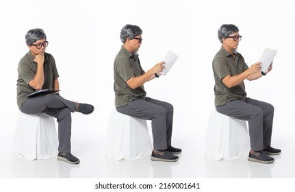 Full Length 50s 60s Asian Chinese Shop Owner Man, Reading Book Newspaper, Wear Formal Casual Dress Sit On Chair. Old Middle Age Male Sitting And Check Calculator Over White Background Isolated