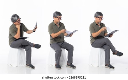 Full Length 50s 60s Asian Chinese Shop Owner Man, Doing Account Tax Finance, Wear Formal Casual Dress Sit On Chair. Old Middle Age Male Sitting And Check Calculator Over White Background Isolated