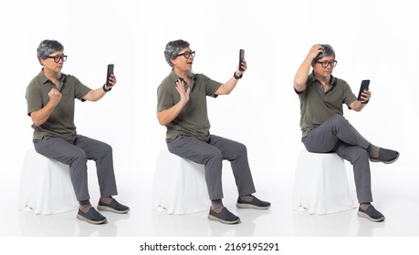 Full Length 50s 60s Asian Chinese Shop Owner Man, Working Internet Phone, Wear Formal Casual Dress Sit On Chair. Old Middle Age Male Sitting And Turn Many Angle Over White Background Isolated