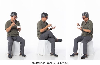 Full Length 50s 60s Asian Chinese Shop Owner Man, Eating Food Chopstick Bowl, Wear Formal Casual Dress Sit On Chair. Old Middle Age Male Sitting And Turn Many Angle Over White Background Isolated