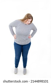 Full length of adorable pretty overweight woman looking down with hands on hips. Isolated on white background 
