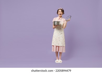 Full length amazed young fun housewife housekeeper chef cook baker woman in pink apron hold soup stainless pan saucepan look camera isolated on pastel violet background Cooking food process concept. - Shutterstock ID 2205894479