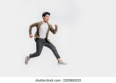 Full length Asian man running jumping in air gesture with happy smile on isolated white background. Cool man joyful running in copy space. Studio short. - Shutterstock ID 2203800233