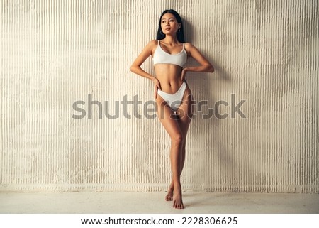 Full length of asian woman of 20s posing, showing her perfect shaped body