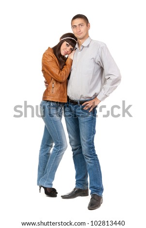 Full length of attractive Caucasian couple standing together on white background