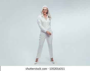 Full Length Of Attractive Mature Woman Standing Over White Background. Beautiful Senior Woman Posing In White Casuals.