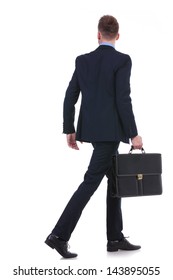 Full Length Back View Picture Of A Young Business Man With A Suitcase In His Hand Walking Away. On White Background